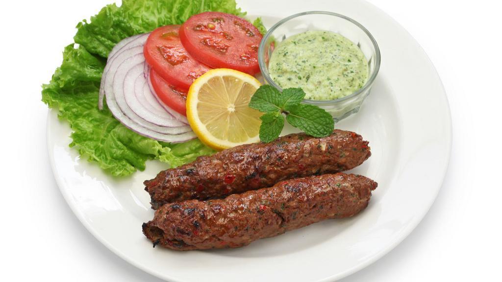 The Lamb Seekh Kebab · Exquisite grounded lamb seasoned with ginger, garlic, red onions and cilantro.