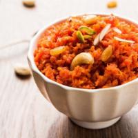 Gajar Halwa · A traditional dessert made of shredded carrots with shaved almonds, raisins and khoya.