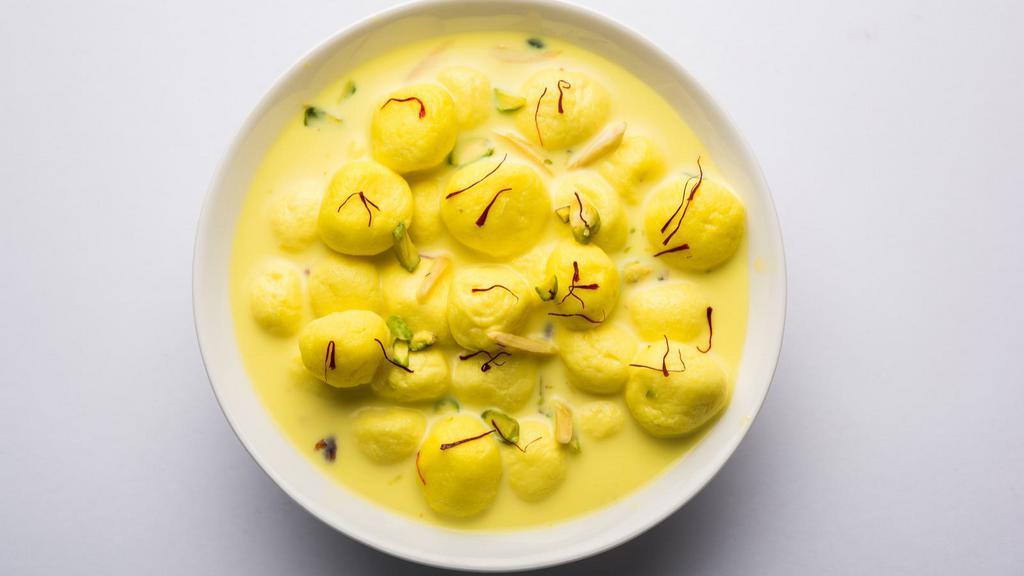Rasmalai · Sweet cottage cheese dumplings in a saffron and cardamom infused milk.