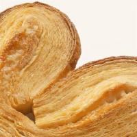 Palmier (Palmier) · A laminated dough puff pastry with alternating layers of dough and butter, rolled and folded...