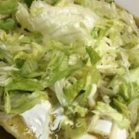 Suiza Enchiladas · Vegetarian. Three oaxaca cheese enchiladas served with sauce, sour cream, cheese, lettuce, r...