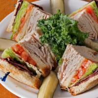 Turkey Club · Fresh turkey, turkey bacon, lettuce, tomato, mayo on three slices of white toast cut into qu...