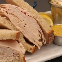 Fresh Turkey Sandwich · Overstuffed, piled high and served with cole slaw and pickles.