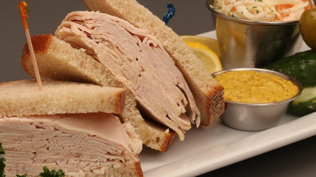 Fresh Turkey Sandwich · Overstuffed, piled high and served with cole slaw and pickles.