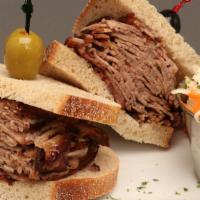 Hot Brisket Sandwich · Overstuffed, piled high and served with cole slaw and pickles.