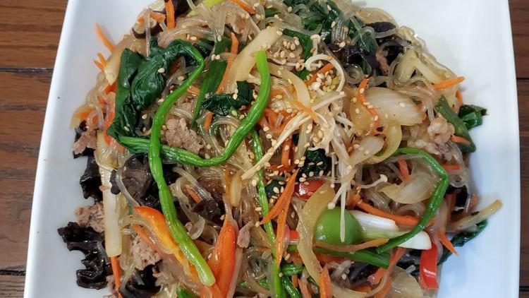 잡채 Japchae · Stir-fried glass noodles with assorted vegetables.