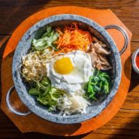돌솥비빔밥 Dolsot Bibimbap · Seasoned vegetables & fried egg over rice in a sizzling stone pot served with a special hous...