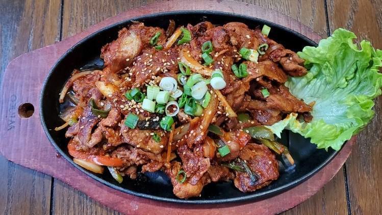 제육볶음 Jae Yook Bokum · Spicy marinated Berkshire pork shoulder stir-fried on a sizzling pan.