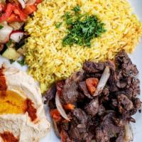 Lamb Shawarma Platter · Juicy lamb with rice, hummus, grilled onions and bell peppers, pickles, and a side of pita.