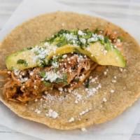 Chicken Tinga · Chicken braised in a sauce of tomato, onion, garlic and chipotle in adobo. Garnished with av...