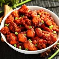 Chicken 65 · Indo-Chinese dish served with chicken cubes tossed with fresh spring onions, lemon leaves, g...