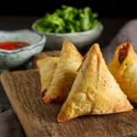 Vegetable Samosa (2 Pieces) · Indian classic samosa with potatoes and peas.
