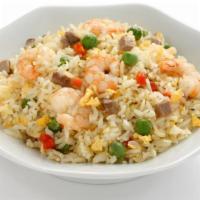 Shrimp Fried Rice · Exquisite rice pearls stir-fried with shrimp, egg, green peas, and carrots.