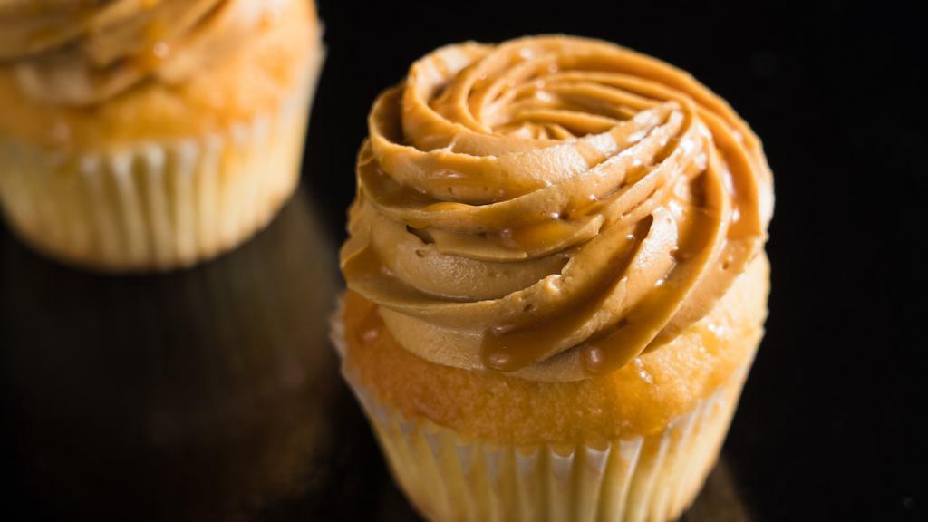 Dulce De Leche · Vanilla cake topped with caramel cream cheese frosting and caramel drizzle.