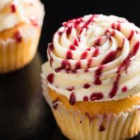 Vanilla Raspberry · Raspberry preserves filled vanilla cake topped with vanilla frosting and raspberry drizzle.