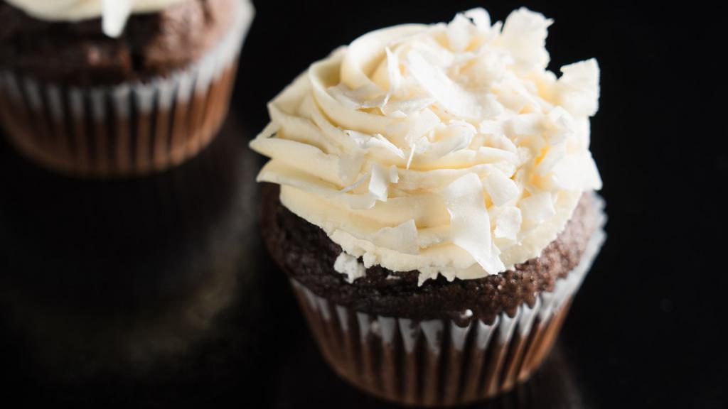 Chocolate Coconut · Classic chocolate cake topped with coconut frosting and coconut flakes.
