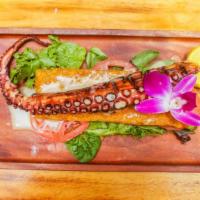 Grilled Octopus · Grilled octopus in a bed of green mix  and tomatoes with al ajillo sauce.