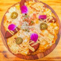 Platano Pizza · Crispy green plantains mofongo, melted cheese, fresh cheese, salami, jalapeños, topped with ...