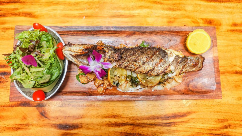 Branzino Carnada · Slow roasted 1.5 to two pounds of whole branzino in a lemon garlic sauce served with roasted potatoes in chipotle sauce.