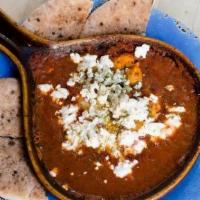 Shakshooka · 2 eggs baked in spicy tomato sauce topped with bulgarian feta and mediterranean herbs. serve...