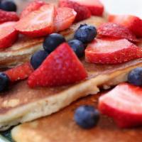 Ricotta Pancakes · topped with fresh seasonal berries and served with maple syrup or date honey on side