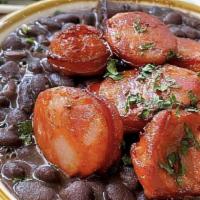Feijoada Do Santo · Brazilian slow cooked black bean & pork stew, with dried meats and sausage, served with whit...
