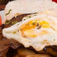 Bistec A La Pobre · Fried steak served with rice, fries, sweet plantain, and a fried egg.
