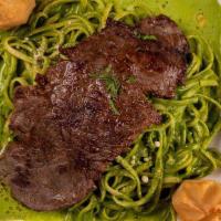 Tallarin Verde Con Bistec · Green pesto spaghetti served with beef steak..