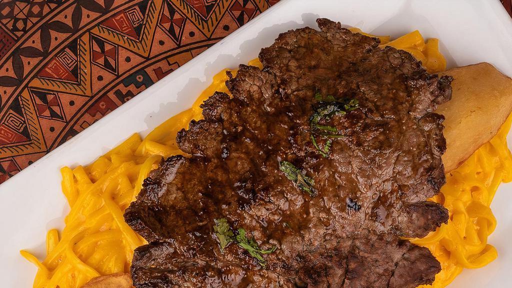 Tallarin A La Huancaina Con Bistec · Spaghetti in Huancaina sauce served with steak.