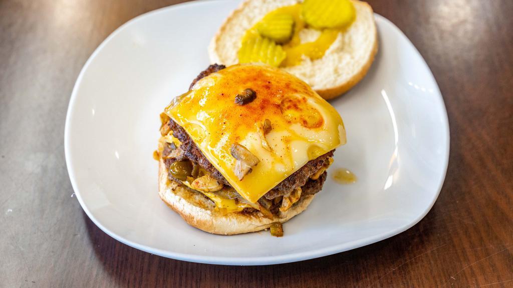 Volcano Burger · Double cheeseburger with jalapeños, mushrooms, American cheese, Swiss cheese, and spicy mayonnaise.