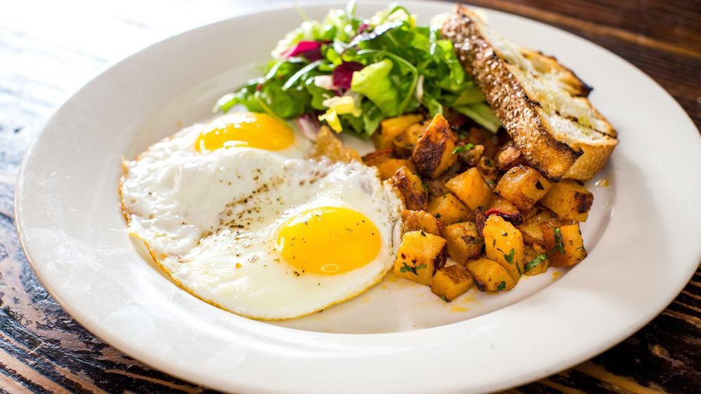 Eggs Any Style · Two eggs, herb-roasted potatoes, and country toast.