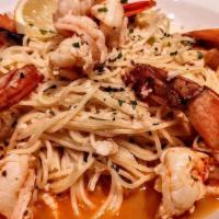 Shrimp Scampi · over angal hair pasta, Italian parsley in a whte wine lemon butter sauce