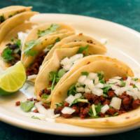 Chorizo Tacos · Artfully made tacos with chorizo, pico de gallo, roasted corn, black beans, creamy cheddar a...