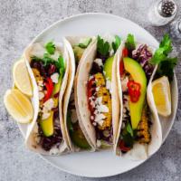 Vegetarian Tacos · Delicious vegetarian tacos with avocado, fresh pico de gallo, roasted corn, black beans, che...