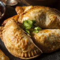 Chicken Empanadas · Crispy fried flour pastry filled with shredded chicken, garlic, olive oil, fresh Sofrito, an...