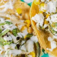 Puebla Rajas Poblanas · Rajas Poblanas - Creamy stewed Poblano. peppers with corn Mexican cream and cheese. Topped w...