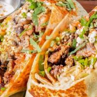 Burrito Skirt Steak · 12’ Flour Tortilla, Mexican rice, black beans, lettuce, queso fresco, crema, corn, pico de g...