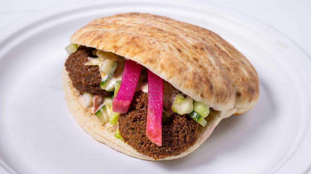 Classic Falafel Sandwich · Freshly made Falafel. Served in a fresh pita bread with salad and Tahini.