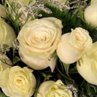 1 Dozen  White Roses Bouquet · 12 white roses wrapped bouquet with filler and greenery.