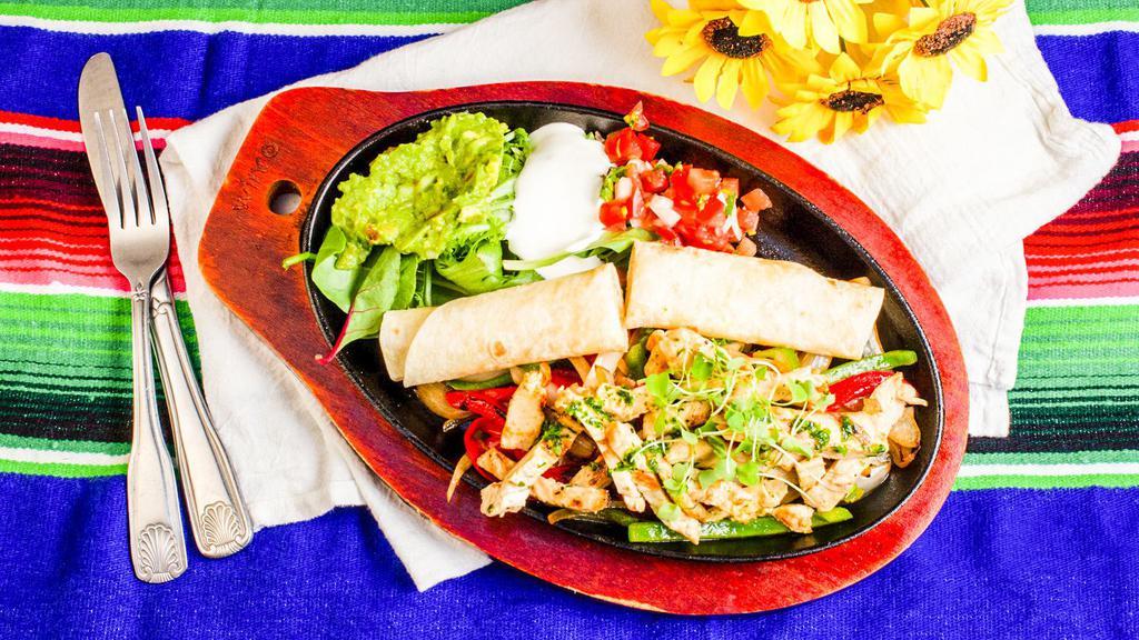 Fajita · Sauteed with onions, peppers and tomatoes served with Mexican rice and beans, flour tortillas on a sizzling platter.