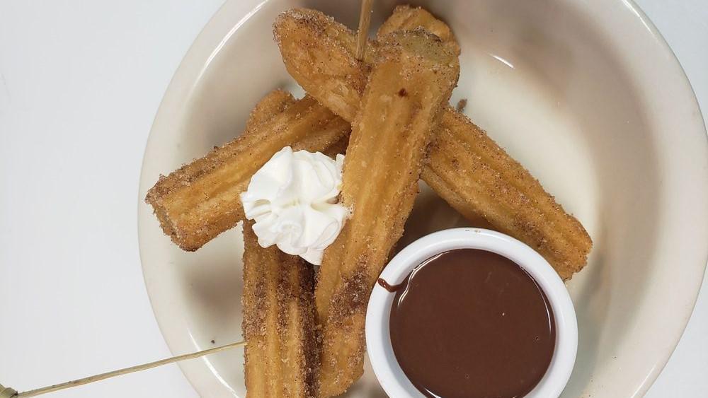 Mexican Churros · Street snack crullers made out of crispy dough dusted with cinnamon sugar and served with warm Mexican chocolate dipping sauce.
