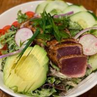 Blackened Ahi Salad · Seared Ahi served on top a bed of mixed greens with cherry tomatoes, cucumbers, avocado with...