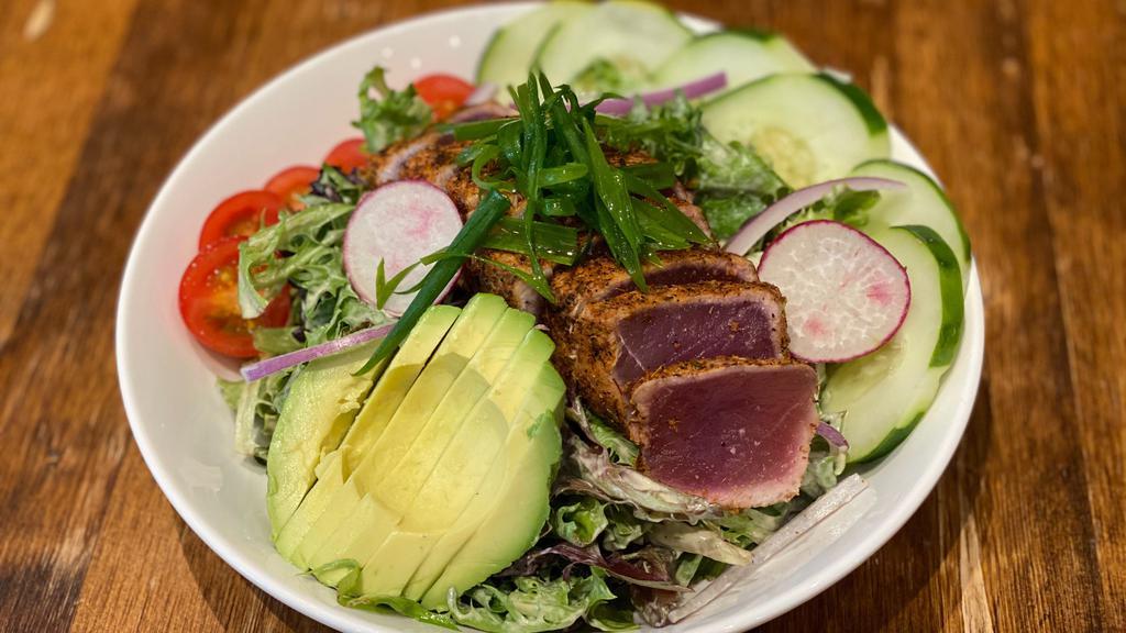 Blackened Ahi Salad · Seared Ahi served on top a bed of mixed greens with cherry tomatoes, cucumbers, avocado with our sesame seed dressing.