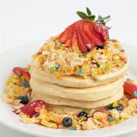 Milk & Cereal Pancakes · Banana, berries, milk syrup, and your choice of cereal topper