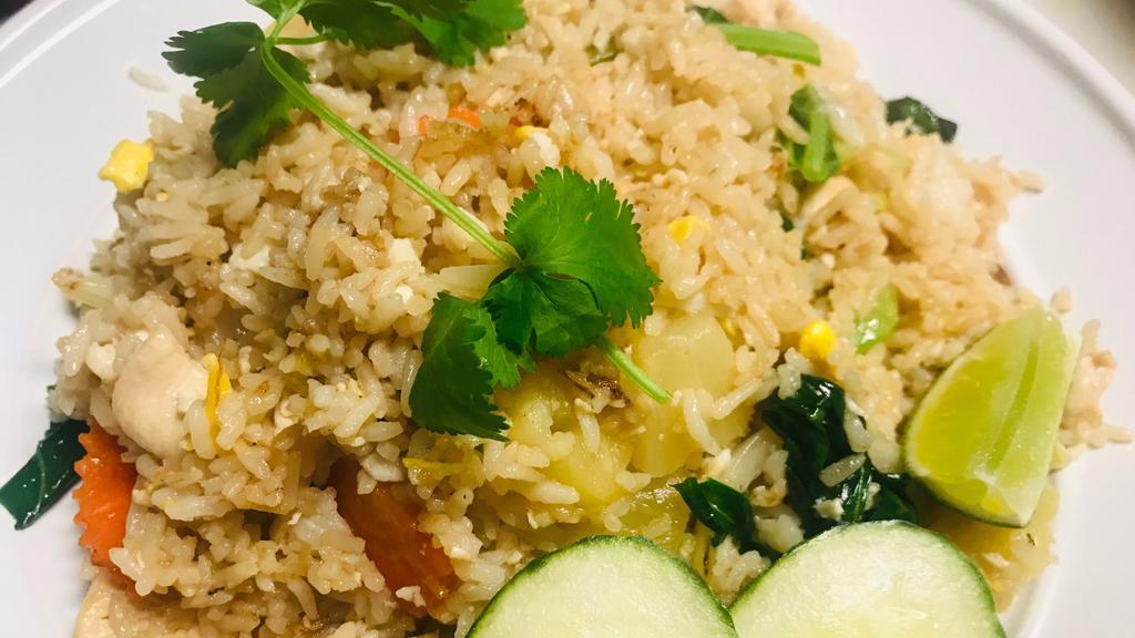 Pineapple Fried Rice · Stir-fried Thai jasmine rice with eggs, pineapple, seasonal mixed vegetables in a light brown sauce.