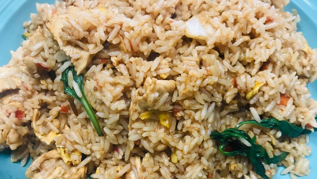 Basil Fried Rice · Stir-fried Thai jasmine rice with eggs, basil, seasonal mixed vegetable in a light brown sauce.