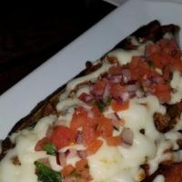Stuffed Sweet Black Beanplantain · Sweet Plantain, filled with black bean and baked on Mozzarella. Topped with Pico de Gallo an...