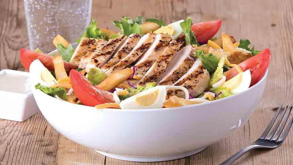 Grilled Chicken Salad · Served over lettuce, tomatoes, onions, cucumbers, and green peppers.