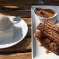 Churros · Cooked, dulce de leche, and chocolate sauces.