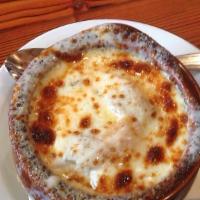 French Onion Soup · Homemade onion soup French style topped with melted mozzarella cheese.